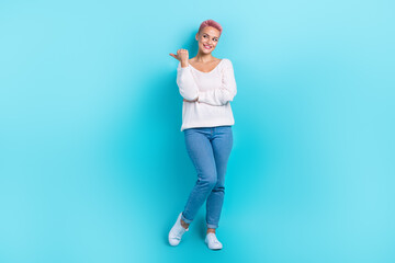 Full length photo of young promoter attractive girl dyed pink hair direct finger look empty space information isolated on aquamarine color background