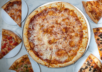 pizza flat lay composition with whole pie and slices