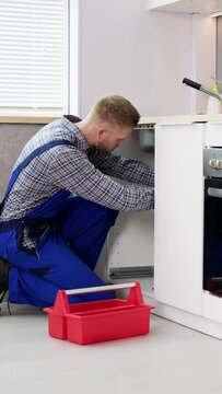 Plumber Cleaning Drain And Pipe