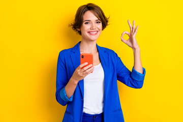 Photo of professional agent lady use gadget browsing ecommerce ads make okay symbol isolated on bright color background