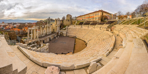 Plovdiv Roman amphitheatre in cloudy day. Ancient roman theatre ruins in Bulgaria. - obrazy, fototapety, plakaty