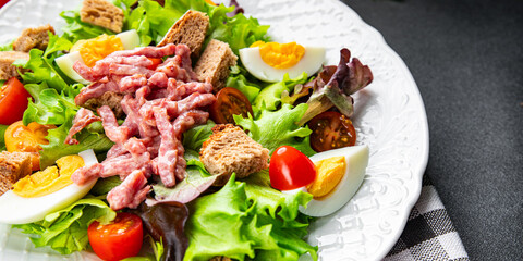 Vosges salad bacon, egg, croutons, lettuce, salad dressing vinaigrette Lorraine cuisine healthy meal food snack on the table copy space food background rustic top view