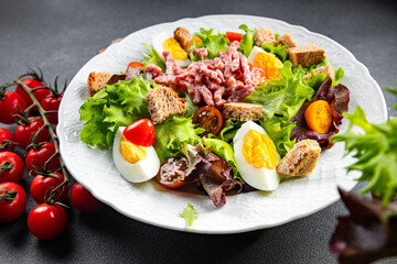 Vosges salad bacon, egg, croutons, lettuce, salad dressing vinaigrette Lorraine cuisine healthy meal food snack on the table copy space food background rustic top view