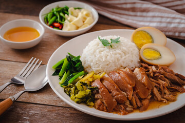 Stewed pork leg with boiled egg and rice on plate