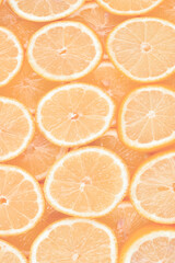 A slices of fresh juicy yellow lemons.  Texture background, pattern.