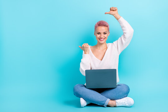 Full length cadre of young promo it specialist point fingers mockup development java script school hold netbook isolated on blue color background