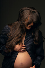 Obraz premium Fashion photo of a pregnant woman.Pregnancy, motherhood, preparation and waiting for childbirth