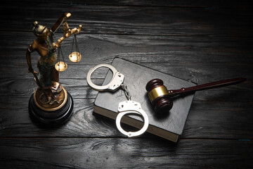  Statue of Lady Justice, handcuffs, book and gavel.