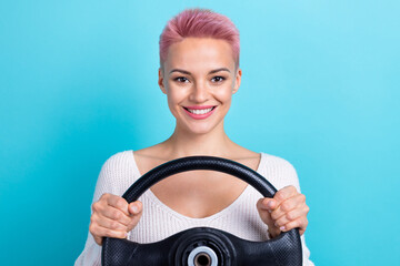 Photo portrait of optimistic cheerful girl drive her expensive car hold steering wheel comfortable speed control isolated on cyan color background