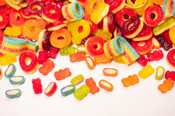 Assorted colorful gummy candies. Top view. Jelly donuts. Jelly bears. Isolated on a white background.