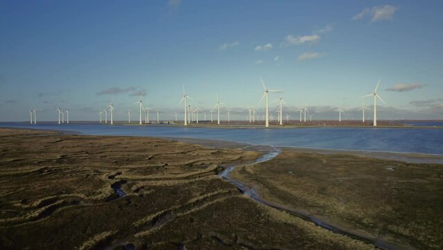 AERIAL VIEW WS Windfarm, dyke and mudflats / Zeeland, Netherlands