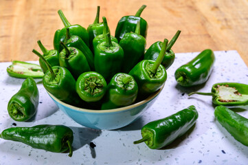 Fresh green mild padron pepper pementos, ready for grill or to be fried with olive oil, traditional snack in Galicia, Spain.