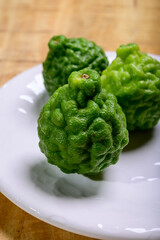 Citrus hystrix, kaffir lime or makrut lime, citrus fruit native to tropical Southeast Asia. Fruit and leaves used in Southeast Asian cuisine, essential oil is used in perfumery for intense citrus