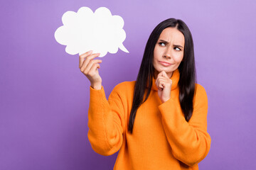 Photo of young funny lady wear orange stylish pullover touch paper cloud minded touch chin look thinking pensive isolated on purple color background