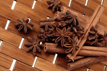 Cinnamon sticks and stars anise over wooden background