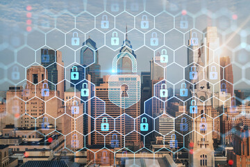 Aerial panoramic cityscape of Philadelphia financial downtown, Pennsylvania, USA. City Hall Clock Tower, sunrise. Padlock hologram. The concept of cyber security to protect confidential information