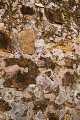 Ancient stone wall fragment. Abstract weathered background.
