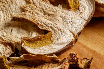 Close up of dried porcini mushrooms. Food and wooden background. Rustic style.