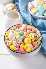 Breakfast easter bunny trail mix. Mixed colorful breakfast cereals and flakes, with chocolate eggs, marshmallow, sugar sprinkles, snacks. Sweets homemade kids Easter morning treats, with milk jug

