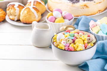 Breakfast easter bunny trail mix. Mixed colorful breakfast cereals and flakes, with chocolate eggs, marshmallow, sugar sprinkles, snacks. Sweets homemade kids Easter morning treats, with milk jug
