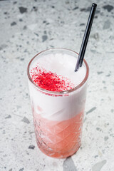 tequila sunrise cocktail on a gray stone bar counter