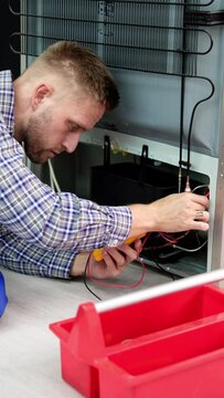 Testing Electric Appliance Using Multimeter To Repair Fridge