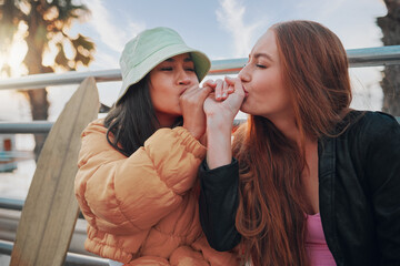 Playful, kiss and friends with a hand promise, support and secret in the city of California. Happy,...