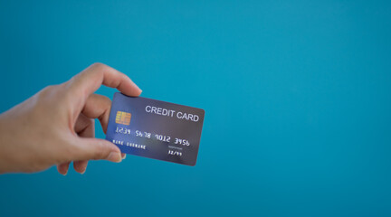 Female hands with credit cards on color background. Bank credit card with online service.