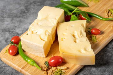 Gruyere cheese. Piece of Gruyere cheese on wooden cutting board. Cheese collection