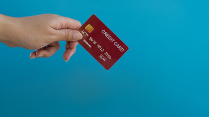 Female hands with credit cards on color background. Bank credit card with online service.