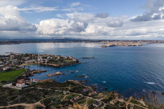 Aerial view of Punta della Mola with Ortigia island on background in Plemmirio Natural Reserve in Syracuse, Sicily, Italy.