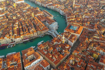 Aerial view of Rialto bridge crossing the Grand Canal in Venice downtown, Veneto, Italy.