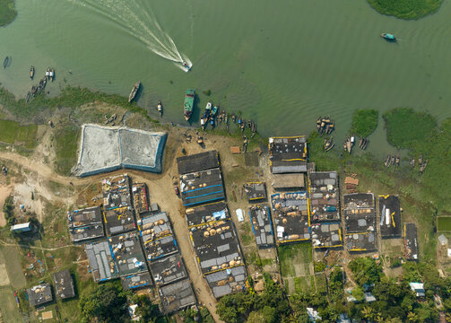 Aerial view of people working in a fish market drying fish at Lalpur Launch Ghat along Meghna River, Chattogram, Bangladesh.