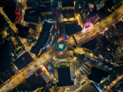 Aerial view of a roundabout with a lily point water fountain at night in Dhaka, Bangladesh.