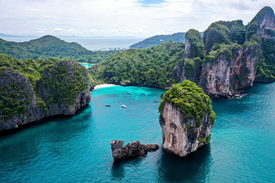 Aerial view of Loh Lana Bay and Nui Beach with high cliffs on Phi Phi island, Thailand.
