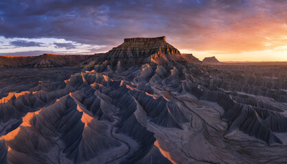 Aerial view of a sandstone Butte in Utah desert valley at sunset, Capitol Reef National Park, Hanksville, United States.
