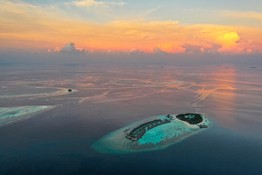 Aerial view of Alif Alif Atoll at sunset on Maldives archipelagos.