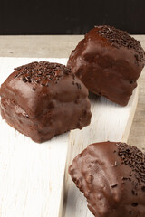 Chocolate honey cookies on wooden table.