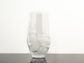 Glass with ice on a black background. Close-up.