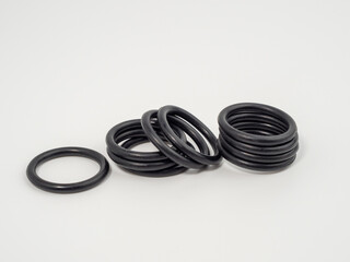 Naklejka premium Hydraulic and pneumatic o-rings in black in different sizes on a white background. Rubber gaskets for plumbing. copy space.
