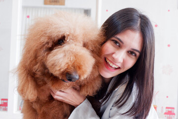Smiling woman hugging a cute brown dog dog love concept.