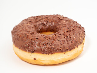 Chocolate donut with chocolate chips on a white background. close-up.