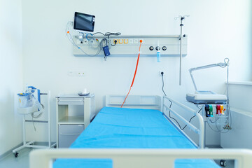 Close-up of empty hospital room with bed.