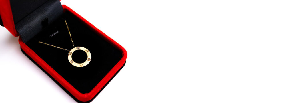 golden jewelry banner on white backgraound, cartier necklace in the box