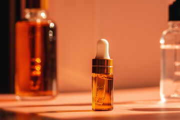Essential oil, face serum or fruit peeling in amber glass dropper bottle. Cosmetics scene backdrop...