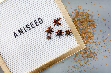Aniseed with pods with letter board reading aniseed.