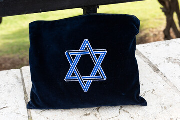 Tallit or Jewish prayer shawl carrying bag embroidered with a star of David. 