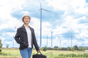 Young Asian businesswoman in suit with electric turbine as background