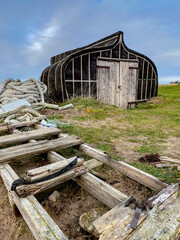 Fototapeta na wymiar An old boathouse near Lindisfarne on Holy Island in Northumberland in the northeast of England.