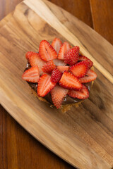 bread dessert, strawberry with hazelnut cream and topped with powdered milk, closeup (selective focus)